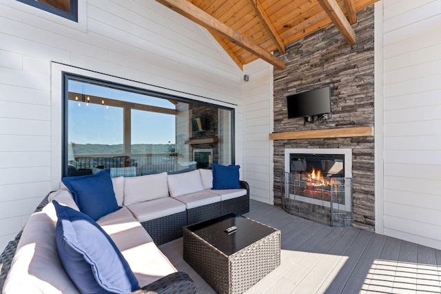 interior space with an outdoor living space with a fireplace