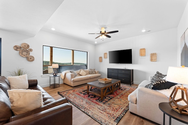 living room with light wood-type flooring and ceiling fan