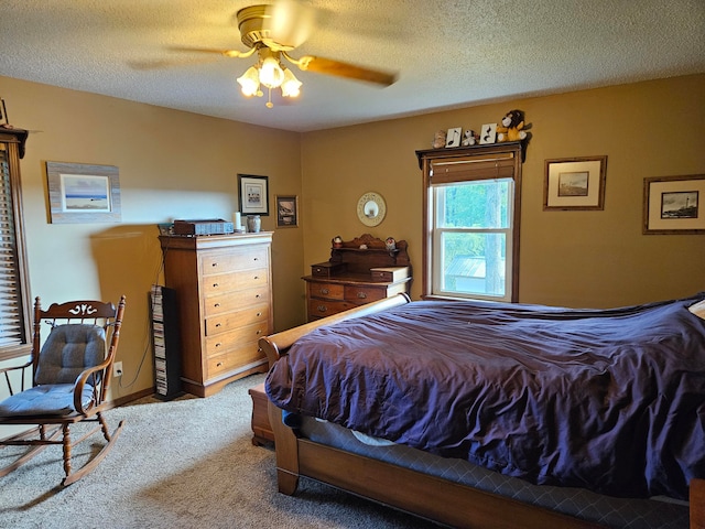 bedroom featuring ceiling fan, a textured ceiling, and carpet flooring