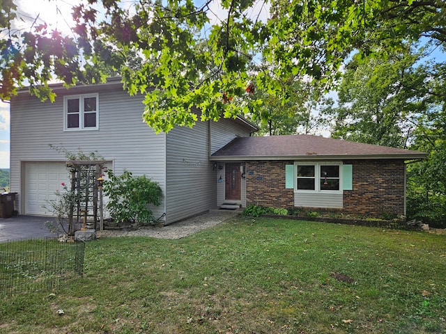 tri-level home featuring a garage and a front yard