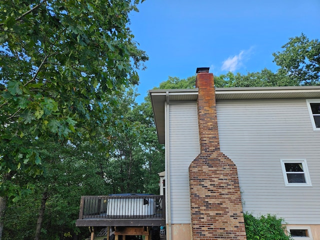 view of property exterior with a wooden deck