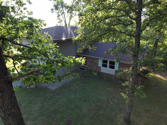 view of side of property with a yard