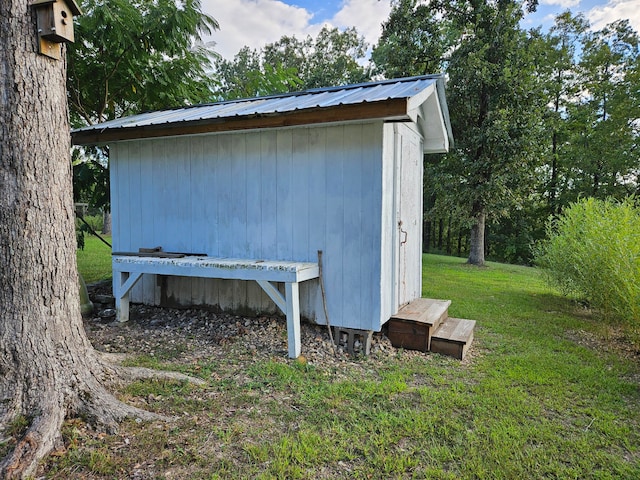 view of outbuilding featuring a yard