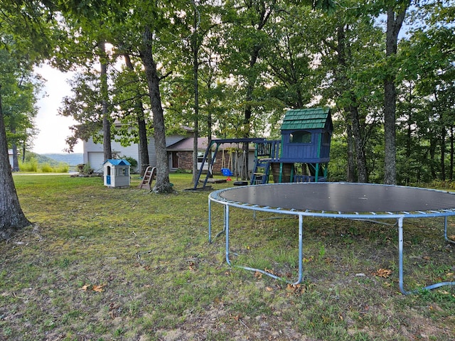 view of yard featuring a playground and a trampoline