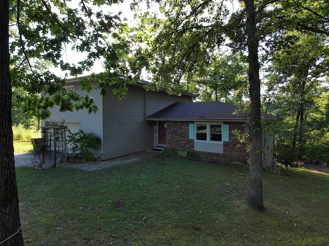 split level home featuring a front lawn