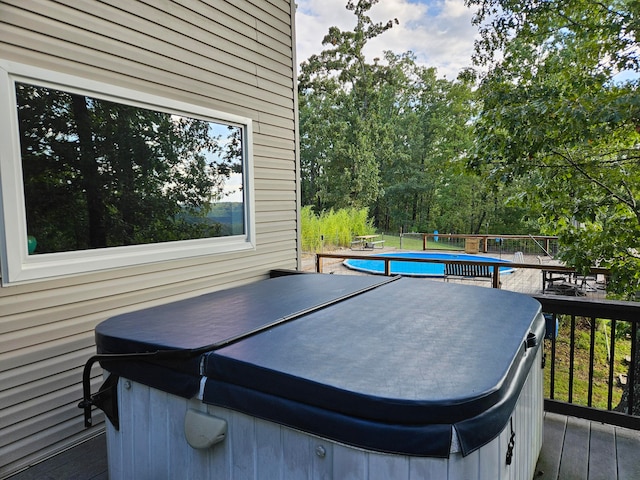 wooden terrace with a pool with hot tub