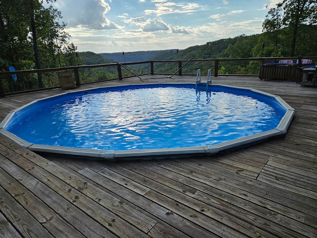 view of swimming pool featuring a deck with mountain view