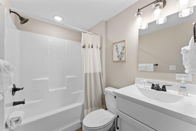 full bathroom with shower / bath combination with curtain, vanity, and toilet