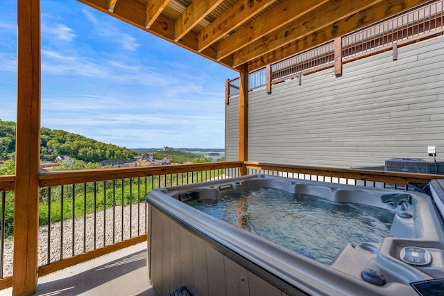 deck featuring a hot tub and central AC unit