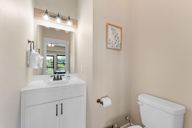 bathroom featuring ceiling fan, vanity, and toilet