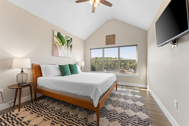 bedroom with ceiling fan, hardwood / wood-style floors, and high vaulted ceiling