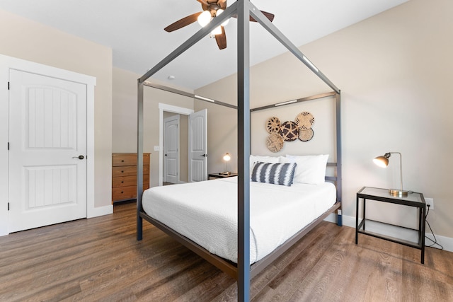 bedroom with dark hardwood / wood-style floors and ceiling fan