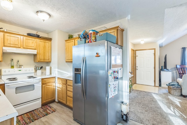 kitchen featuring stainless steel fridge, light hardwood / wood-style flooring, a textured ceiling, and electric stove