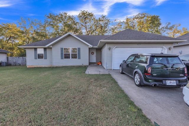 single story home featuring a front lawn and a garage