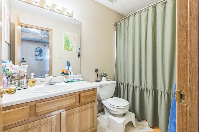 bathroom with vanity, a textured ceiling, a shower with curtain, and toilet