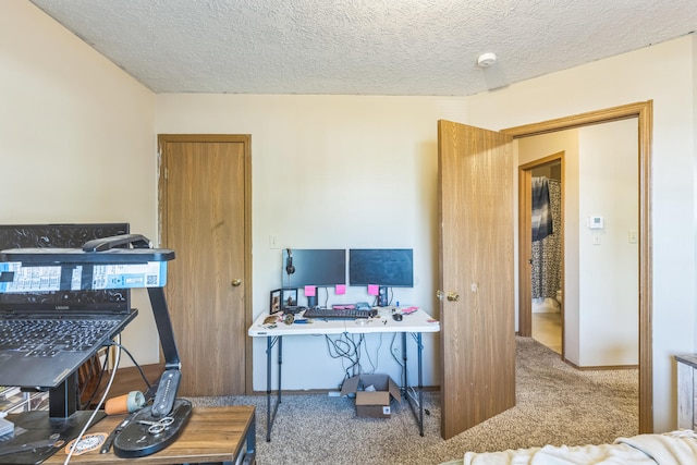 carpeted office with a textured ceiling