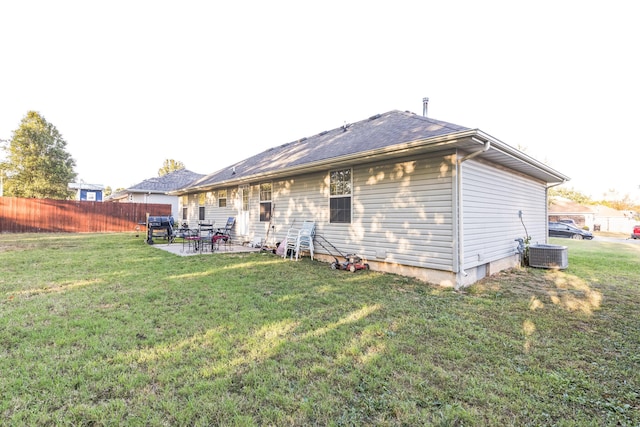 back of property featuring a patio area, central AC, and a lawn