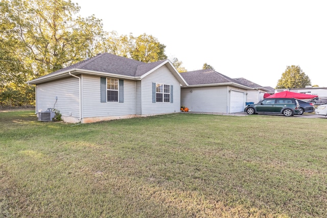 view of front of home with a front yard and a garage