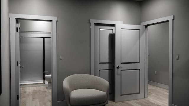 interior space featuring connected bathroom and light hardwood / wood-style floors