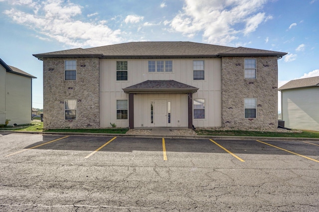 rear view of house featuring uncovered parking