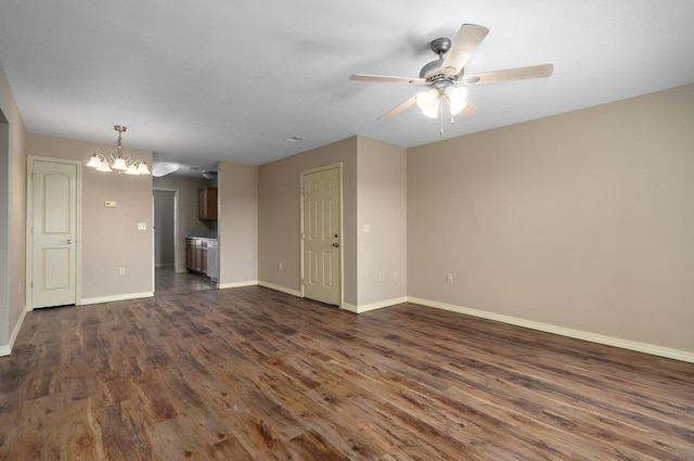 unfurnished living room with ceiling fan with notable chandelier, baseboards, and dark wood finished floors