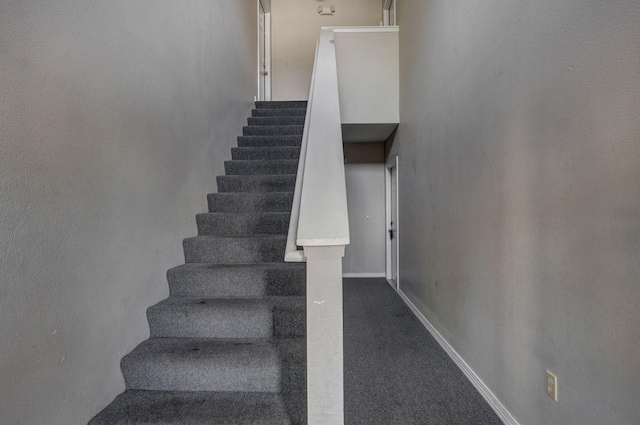 staircase featuring baseboards