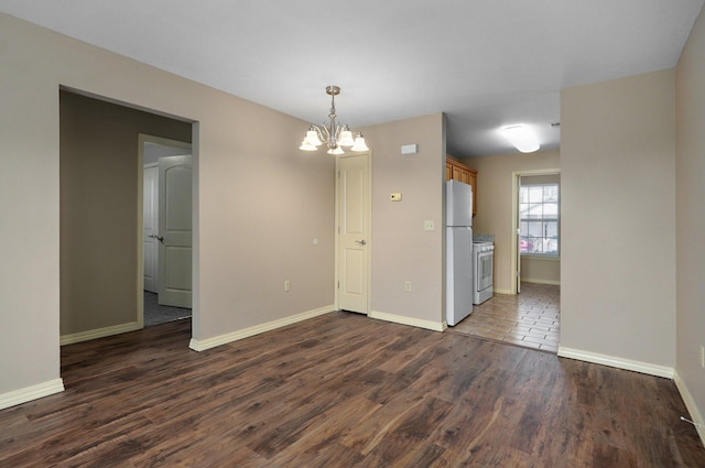 empty room with baseboards, a chandelier, and dark wood-type flooring