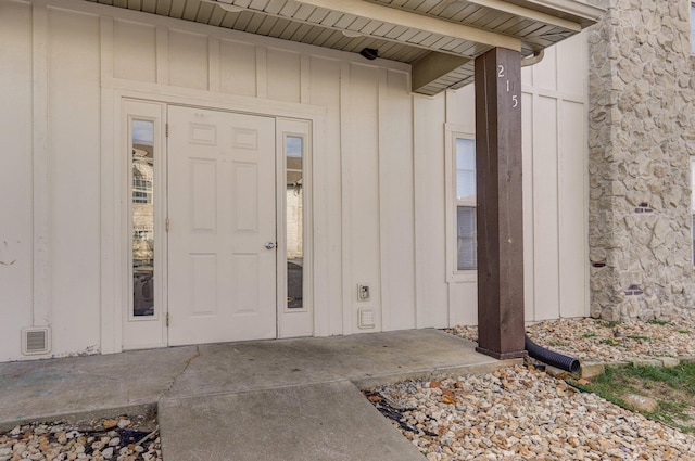 view of exterior entry with board and batten siding