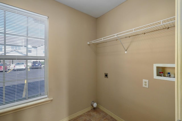 clothes washing area with electric dryer hookup, baseboards, laundry area, and washer hookup
