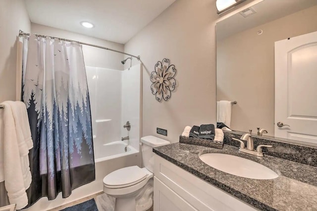 full bathroom featuring vanity, shower / tub combo, and toilet