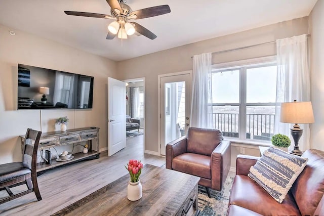 living room featuring ceiling fan and light hardwood / wood-style floors