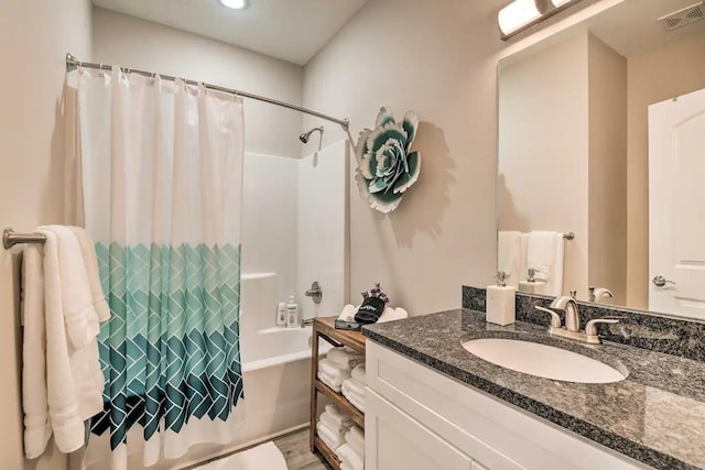 bathroom featuring shower / bath combo with shower curtain, hardwood / wood-style floors, and vanity