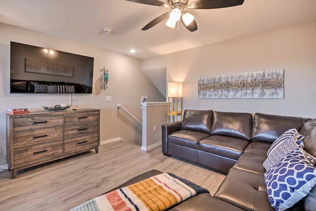 living room with ceiling fan and light hardwood / wood-style flooring