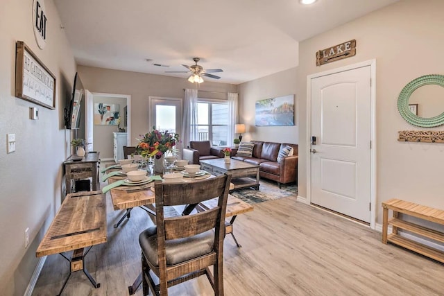 dining room with light hardwood / wood-style floors and ceiling fan