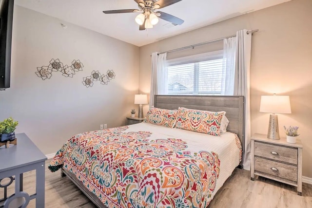 bedroom with light hardwood / wood-style floors and ceiling fan