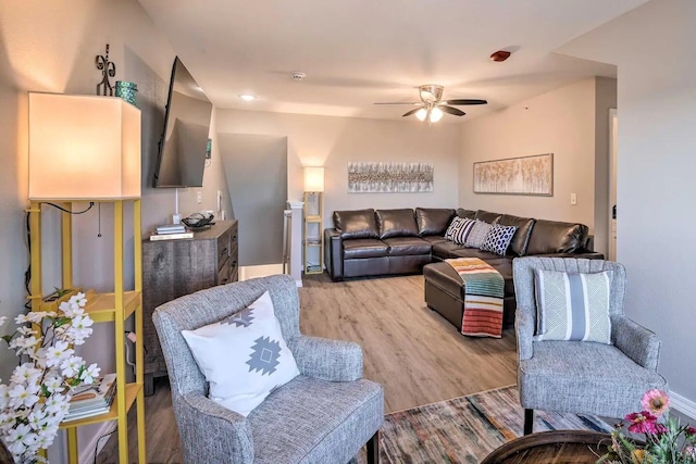 living room with ceiling fan and hardwood / wood-style floors