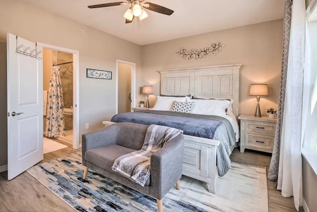 bedroom featuring ceiling fan, connected bathroom, and light hardwood / wood-style flooring