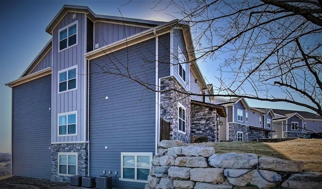 property exterior at dusk featuring central AC unit