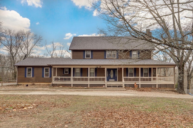 farmhouse inspired home with covered porch, roof with shingles, a chimney, and a front lawn