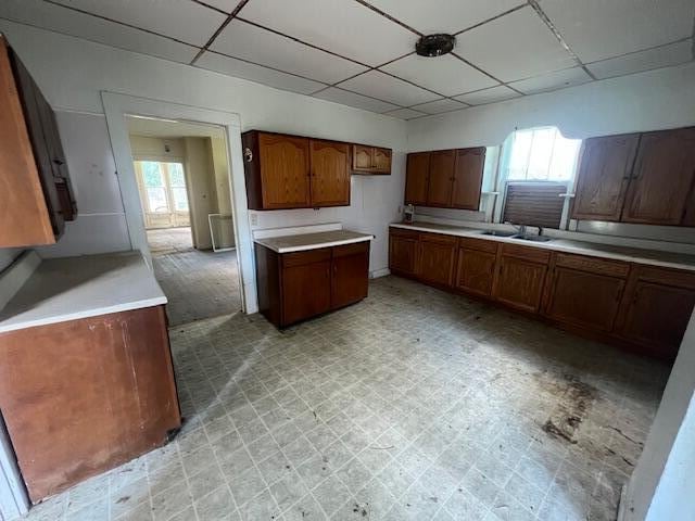 kitchen featuring a paneled ceiling and sink