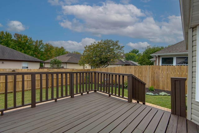 wooden deck featuring a lawn