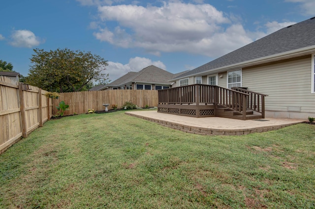 view of yard featuring a patio and a deck