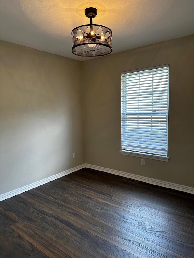 spare room featuring dark hardwood / wood-style floors