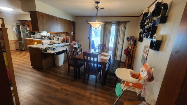 dining space featuring hardwood / wood-style flooring and sink