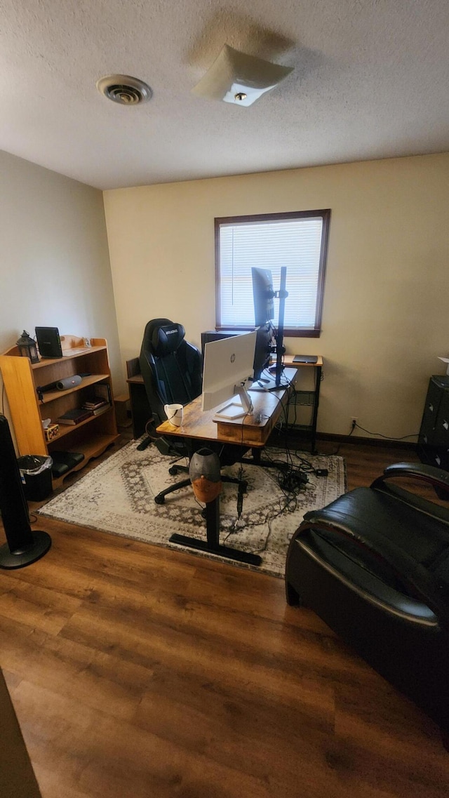 office area featuring hardwood / wood-style flooring and a textured ceiling