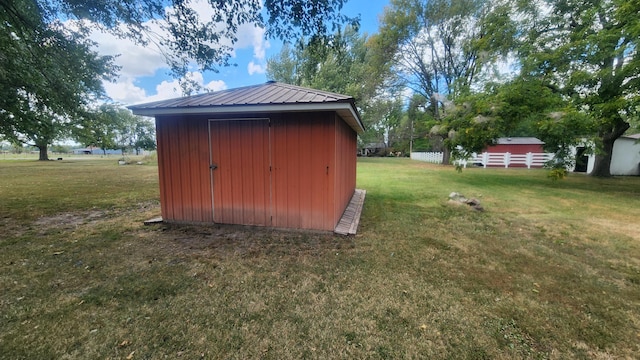 view of outbuilding with a yard