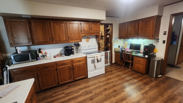 kitchen with built in desk, white electric stove, and dark hardwood / wood-style flooring