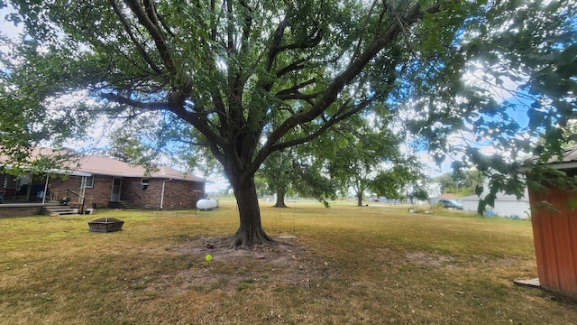 view of yard with an outdoor fire pit