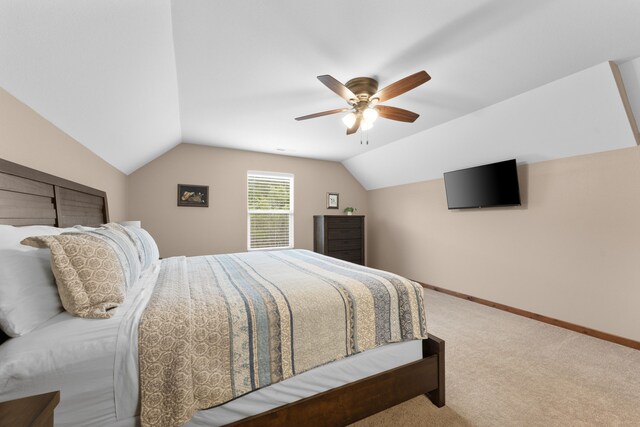 carpeted bedroom with ceiling fan and vaulted ceiling