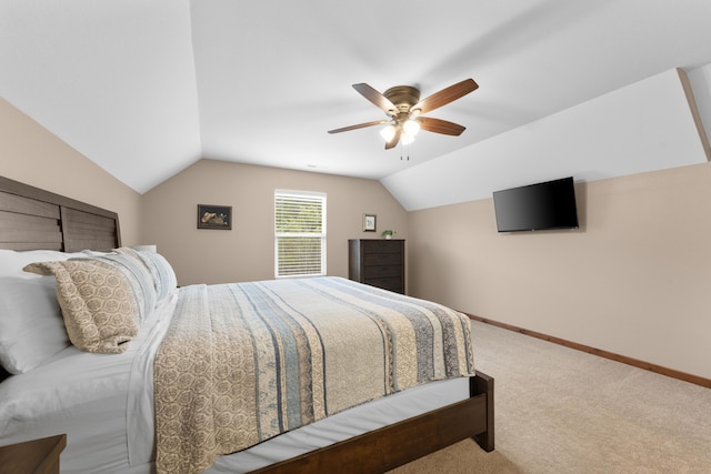 carpeted bedroom featuring vaulted ceiling, a ceiling fan, and baseboards